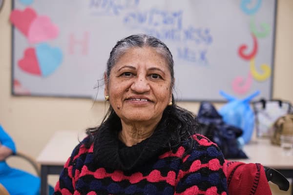 A woman smiles at the camera