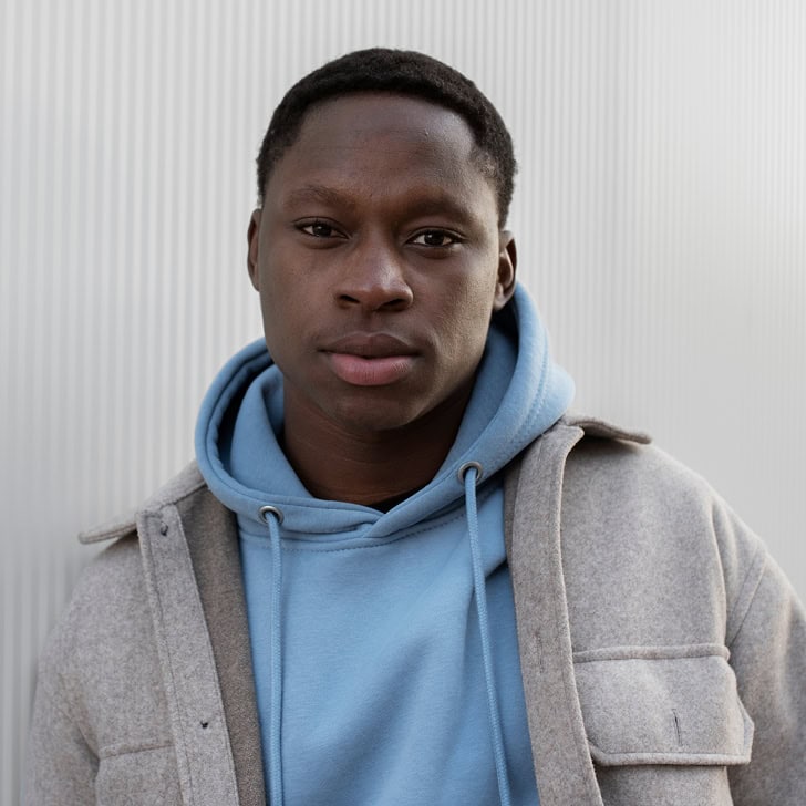 A young man looks at the camera.