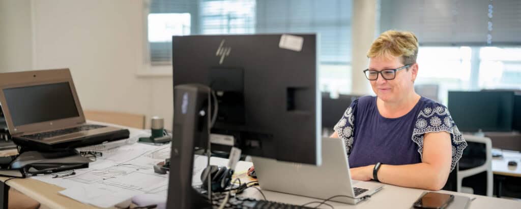 A woman in an office sitting in front of a computer