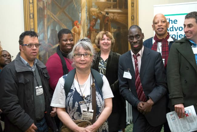A group of Advocacy Project service users face the camera smiling